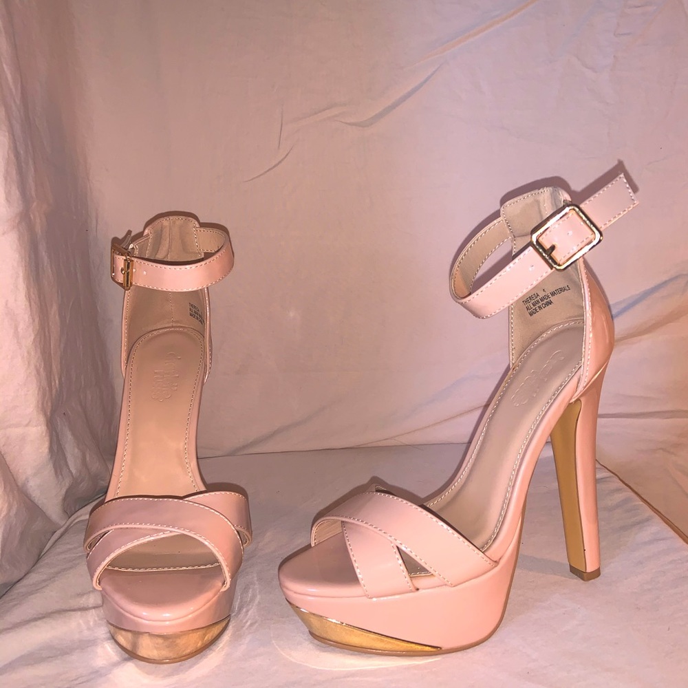 The heels are a nude pink with some gold.
